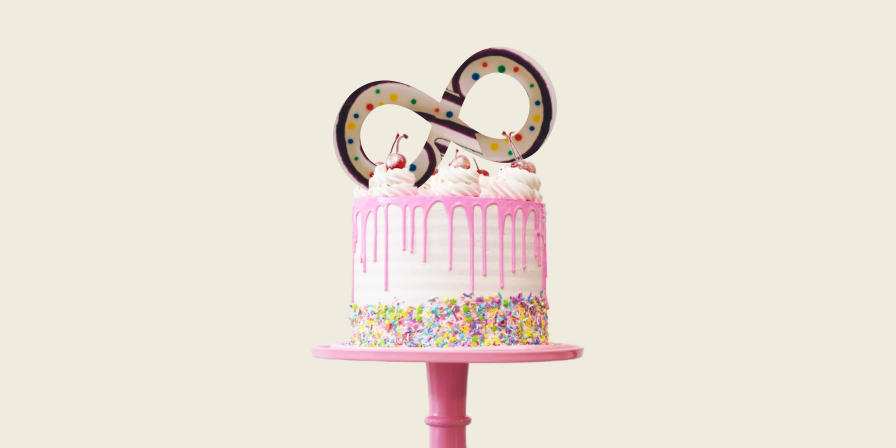 A birthday cake with infinity symbol as decoration